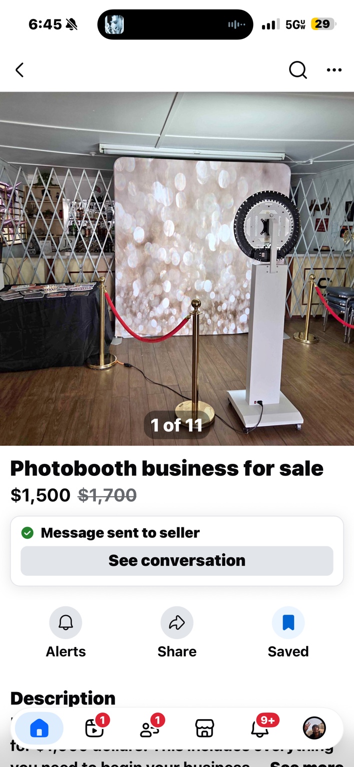 Seller's setup with fabric backdrop, prop table, kiosk and gold stanchions